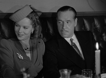 Movie still from “Cat People” (1942), directed by Jacques Tourneur – An older man sitting next to an older woman; Close Up shot, Low angle