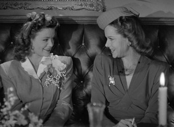 Movie still from “Cat People” (1942), directed by Jacques Tourneur – A couple of women sitting next to each other on a couch; Medium shot, High angle