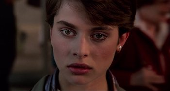 Movie still from “Cat People” (1982), directed by Paul Schrader – A woman's face with a piercing; Close Up shot, Over the shoulder angle