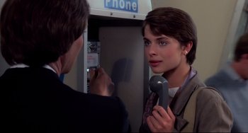 Movie still from “Cat People” (1982), directed by Paul Schrader – A woman holding a phone up to her face; Close Up shot, Over the shoulder angle