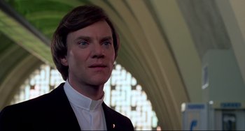 Movie still from “Cat People” (1982), directed by Paul Schrader – A person wearing a suit and tie; Close Up shot, Low angle