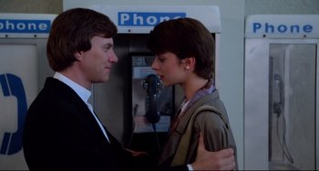 Movie still from “Cat People” (1982), directed by Paul Schrader – A man and a woman standing in front of a pay phone; Close Up shot, Low angle