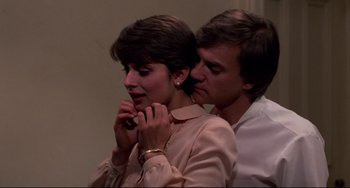 Movie still from “Cat People” (1982), directed by Paul Schrader – A man and a woman standing next to each other; Close Up shot, Low angle