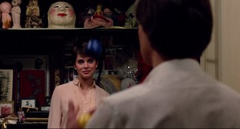 Movie still from “Cat People” (1982), directed by Paul Schrader – A woman standing in front of a man in a room; Close Up shot, Over the shoulder angle