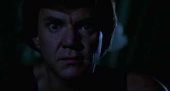 Movie still from “Cat People” (1982), directed by Paul Schrader – A person's face in the dark; Close Up shot, Low angle