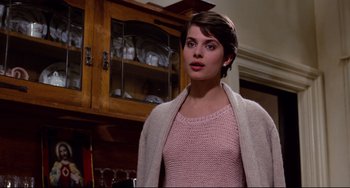 Movie still from “Cat People” (1982), directed by Paul Schrader – A woman standing in front of a wooden cabinet; Close Up shot, Over the shoulder angle