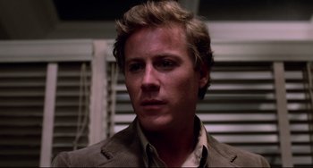 Movie still from “Cat People” (1982), directed by Paul Schrader – A person wearing a jacket; Close Up shot, Low angle