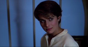 Movie still from “Cat People” (1982), directed by Paul Schrader – A woman with short brown hair wearing a white shirt; Close Up shot, Over the shoulder angle