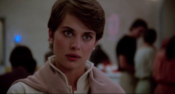 Movie still from “Cat People” (1982), directed by Paul Schrader – A person with short brown hair; Close Up shot, Over the shoulder angle