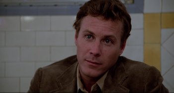 Movie still from “Cat People” (1982), directed by Paul Schrader – A person wearing a suit and tie; Close Up shot, Over the shoulder angle