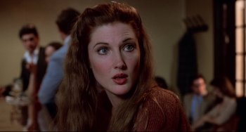 Movie still from “Cat People” (1982), directed by Paul Schrader – A person with long brown hair; Close Up shot, High angle