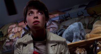 Movie still from “Cat People” (1982), directed by Paul Schrader – A woman in a tan jacket looking up at the ceiling; Close Up shot, Low angle