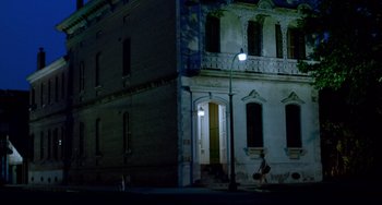 Movie still from “Cat People” (1982), directed by Paul Schrader – A person walking down a street at night; Extreme Wide shot, Low angle