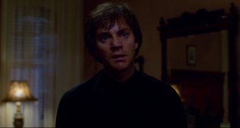 Movie still from “Cat People” (1982), directed by Paul Schrader – A man in a black shirt is looking at the camera; Close Up shot, Low angle