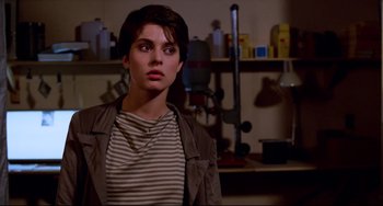 Movie still from “Cat People” (1982), directed by Paul Schrader – A woman in a striped shirt is looking at the camera; Close Up shot, Low angle