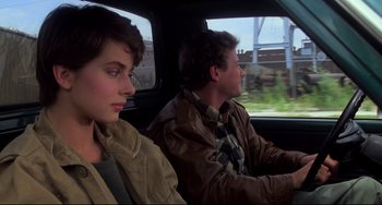 Movie still from “Cat People” (1982), directed by Paul Schrader – A man and a woman sitting in the back of a car; Medium shot, Over the shoulder angle