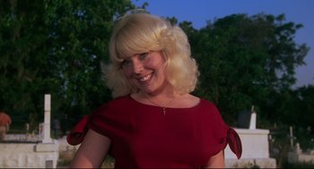 Movie still from “Cat People” (1982), directed by Paul Schrader – A woman with blonde hair wearing a red dress; Close Up shot, Low angle