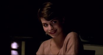 Movie still from “Cat People” (1982), directed by Paul Schrader – A beautiful young lady sitting in front of a window; Close Up shot, Over the shoulder angle