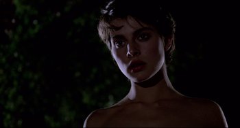 Movie still from “Cat People” (1982), directed by Paul Schrader – A young woman with short dark hair is posing for the camera; Close Up shot, Low angle