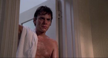 Movie still from “Cat People” (1982), directed by Paul Schrader – A shirtless man with a towel around his neck; Close Up shot, Low angle
