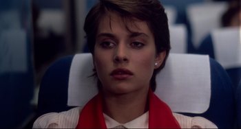 Movie still from “Cat People” (1982), directed by Paul Schrader – A woman with short brown hair sitting in a chair; Close Up shot, Low angle