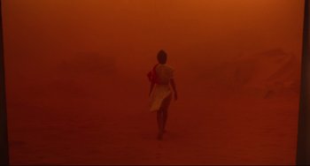 Movie still from “Cat People” (1982), directed by Paul Schrader – A woman walking through a dusty field in a red sky; Extreme Wide shot, Over the shoulder angle