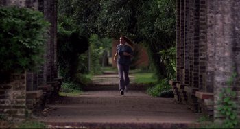 Movie still from “Cat People” (1982), directed by Paul Schrader – A man is running down a path in the woods; Wide shot, Low angle