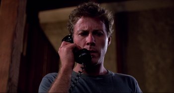 Movie still from “Cat People” (1982), directed by Paul Schrader – A man holding a phone up to his ear; Close Up shot, Low angle