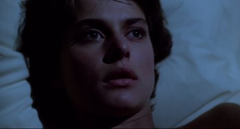 Movie still from “Cat People” (1982), directed by Paul Schrader – A woman's face in the dark; Close Up shot, Overhead angle