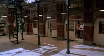 Movie still from “Cat People” (1982), directed by Paul Schrader – A couple of people are standing in a train station; Extreme Wide shot, High angle