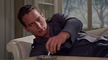 Movie still from “Cat on a Hot Tin Roof” (1958), directed by Richard Brooks – A person sitting on a couch; Close Up shot, Low angle