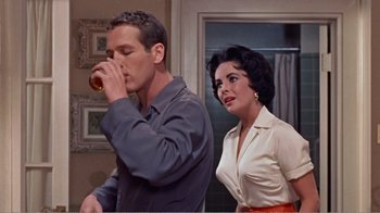 Movie still from “Cat on a Hot Tin Roof” (1958), directed by Richard Brooks – A man and a woman standing next to each other; Medium shot, Over the shoulder angle