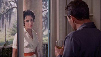 Movie still from “Cat on a Hot Tin Roof” (1958), directed by Richard Brooks – A man and a woman looking at each other in a doorway; Medium shot, Over the shoulder angle