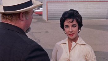 Movie still from “Cat on a Hot Tin Roof” (1958), directed by Richard Brooks – An older woman wearing a white shirt and a hat; Close Up shot, Over the shoulder angle