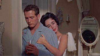 Movie still from “Cat on a Hot Tin Roof” (1958), directed by Richard Brooks – A man and a woman holding a wine glass in a room; Medium shot, Low angle