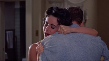 Movie still from “Cat on a Hot Tin Roof” (1958), directed by Richard Brooks – A man and a woman hugging in a room; Close Up shot, High angle