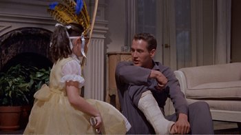Movie still from “Cat on a Hot Tin Roof” (1958), directed by Richard Brooks – A man and a little girl in a living room; Medium shot, Over the shoulder angle