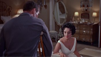 Movie still from “Cat on a Hot Tin Roof” (1958), directed by Richard Brooks – A man and a woman sitting at a dining table; Medium shot, Over the shoulder angle
