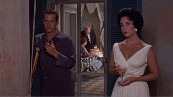Movie still from “Cat on a Hot Tin Roof” (1958), directed by Richard Brooks – A man and a woman standing next to each other; Medium shot, Over the shoulder angle