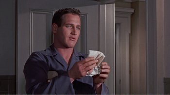 Movie still from “Cat on a Hot Tin Roof” (1958), directed by Richard Brooks – A man holding a napkin in his hands; Close Up shot, Low angle