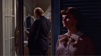 Movie still from “Cat on a Hot Tin Roof” (1958), directed by Richard Brooks – A man and a woman standing next to each other in front of a mirror; Medium shot, Over the shoulder angle