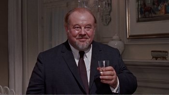 Movie still from “Cat on a Hot Tin Roof” (1958), directed by Richard Brooks – A man in a suit holding a glass of wine; Close Up shot, Low angle