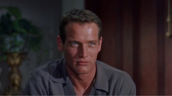 Movie still from “Cat on a Hot Tin Roof” (1958), directed by Richard Brooks – A person wearing a gray shirt; Close Up shot, High angle