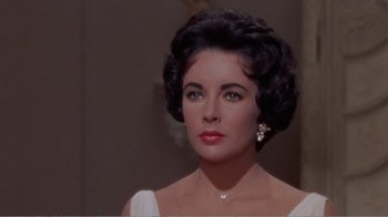 Movie still from “Cat on a Hot Tin Roof” (1958), directed by Richard Brooks – A person wearing a dress; Close Up shot, Over the shoulder angle
