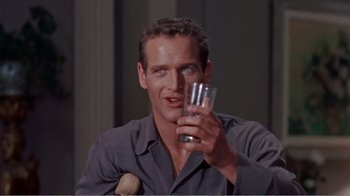 Movie still from “Cat on a Hot Tin Roof” (1958), directed by Richard Brooks – A person holding a glass of water; Close Up shot, Low angle