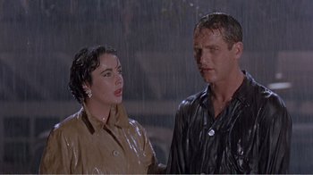 Movie still from “Cat on a Hot Tin Roof” (1958), directed by Richard Brooks – A man and a woman standing in the pouring rain; Medium shot, Low angle