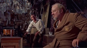 Movie still from “Cat on a Hot Tin Roof” (1958), directed by Richard Brooks – Two men sitting on a chair in a living room; Medium shot, Over the shoulder angle