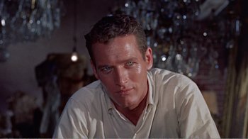 Movie still from “Cat on a Hot Tin Roof” (1958), directed by Richard Brooks – A person wearing a white shirt; Close Up shot, Low angle