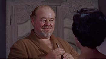 Movie still from “Cat on a Hot Tin Roof” (1958), directed by Richard Brooks – An older man with a beard and mustache holding a pen; Close Up shot, Over the shoulder angle