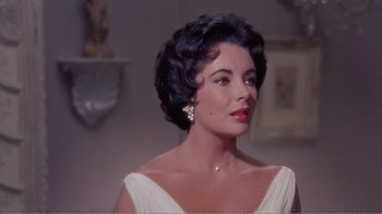 Movie still from “Cat on a Hot Tin Roof” (1958), directed by Richard Brooks – A person wearing a dress; Close Up shot, Over the shoulder angle